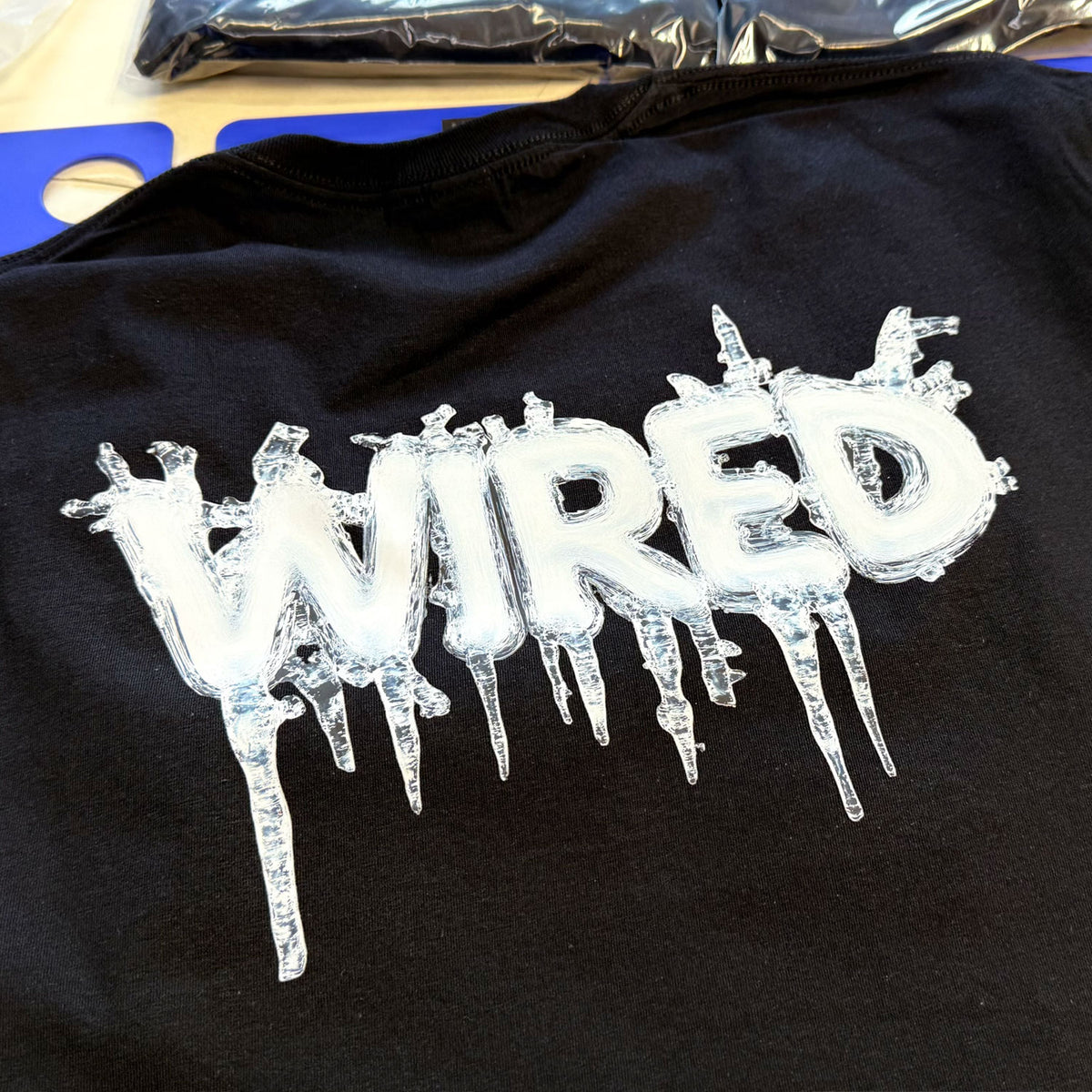 Wired &#39;ICED&#39; T-Shirt displaying frozen logo design on black cotton fabric.