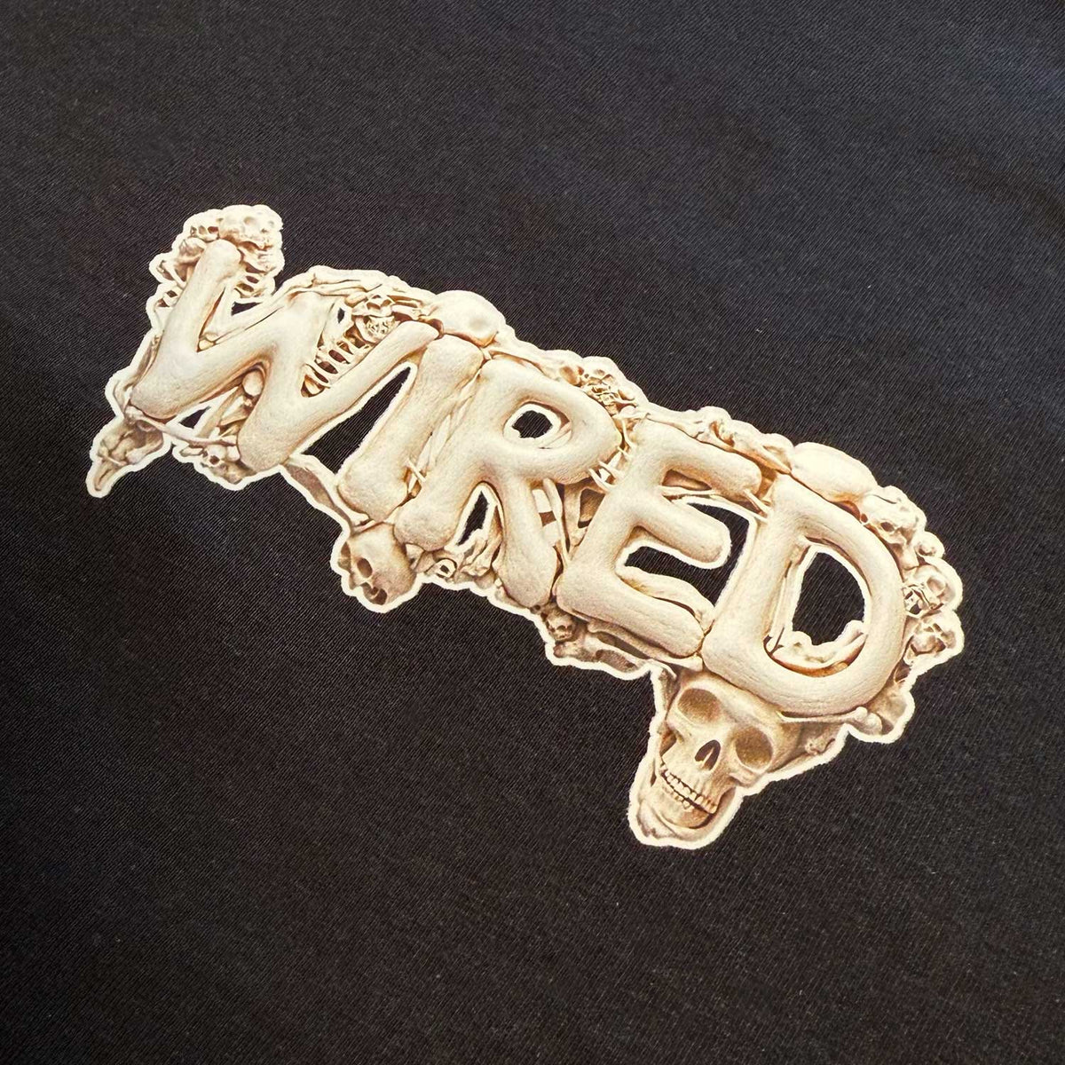Wired &#39;BONES&#39; T-Shirt featuring skeleton-inspired artwork on black cotton fabric.