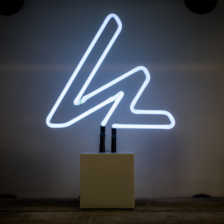 Wired Logo Neon Desktop Sign glowing white with AC plug.